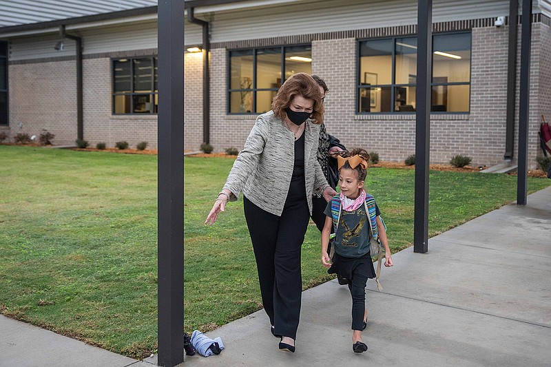 Margaret Fischer Davis, former Superintendent for Pleasant Grove Independent School District, directs Rosemary Deal to the cafeteria on her first day at the Margaret Fischer Davis elementary school. The school opened for students on November 9th.