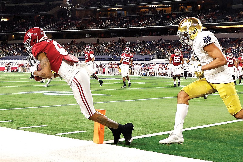 Alabama wide receiver DeVonta Smith catches a pass in the front corner of the end zone for a touchdown as Notre Dame cornerback Nick McCloud defends in the second half of the Rose Bowl on Friday in Arlington, Texas.