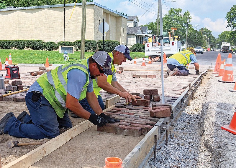 Fulton workers return some of the city's famed Brick District bricks to their rightful home at the intersection of Fifth and Jefferson on Aug. 10, 2020. While improvements were underway on Jefferson Street, the bricks were stored in city warehouses.