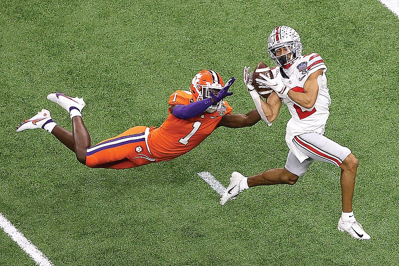 Ohio State receiver Chris Olave catches a touchdown pass in front of Clemson cornerback Derion Kendrick during the Sugar Bowl on Friday in New Orleans.