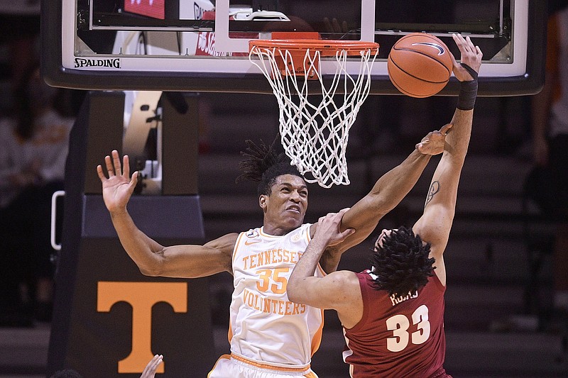 Tennessee's Yves Pons blocks a shot by Alabama's James Rojas during Saturday's game in Knoxville, Tenn.