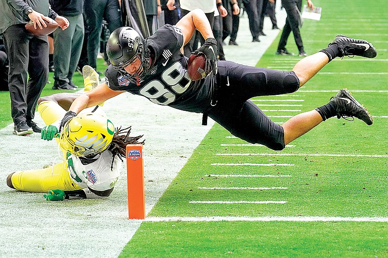 Iowa State tight end Charlie Kolar is stopped short of the goal line by Oregon safety Jamal Hill during the first half of the Fiesta Bowl on Saturday in Glendale, Ariz.