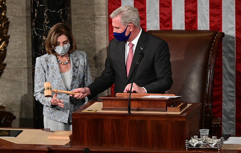 Speaker of the House Nancy Pelosi is handed the Speaker's gavel by House Minority Leader Kevin McCarthy, R-Calif., on the opening day of the 117th Congress on Capitol Hill in Washington, Sunday, Jan. 3, 2021. (Erin Scott/Pool via AP)