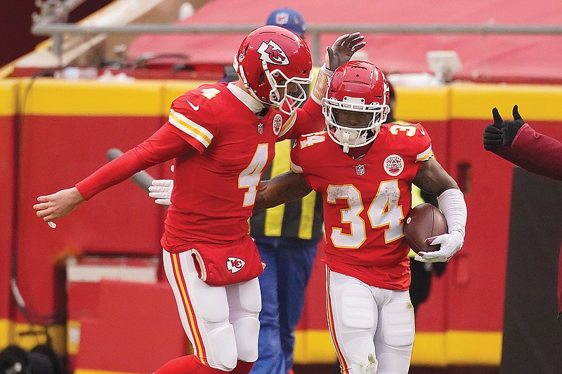 Chiefs running back Darwin Thompson celebrates with quarterback Chad Henne after scoring on a 1-yard run during Sunday's game against the Chargers at Arrowhead Stadium.