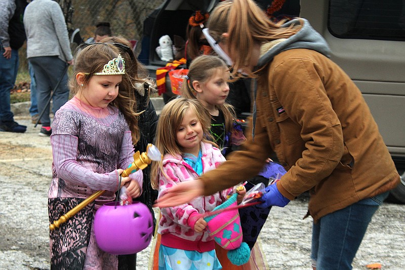 Staff members and their families handed out candy to princesses, witches, superheroes and animals at a Trunk-or-Treat hosted by Central Missouri Community Action's Fulton Head Start.