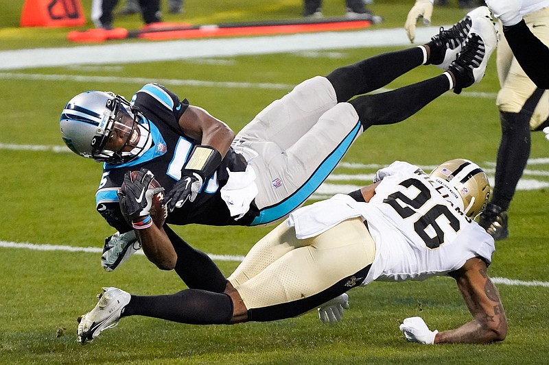 Carolina Panthers quarterback Teddy Bridgewater is tackled by New Orleans Saints cornerback P.J. Williams during the first half of an NFL football game Sunday, Jan. 3, 2021, in Charlotte, N.C. (AP Photo/Gerry Broome)