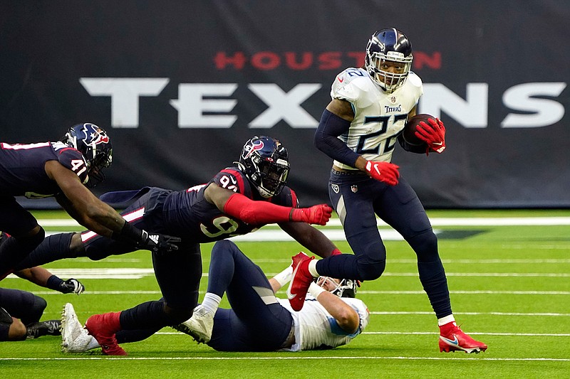Tennessee Titans running back Derrick Henry (22) breaks away from Houston Texans defensive end Charles Omenihu (94) during the second half of an NFL football game Sunday, Jan. 3, 2021, in Houston. (AP Photo/Sam Craft)