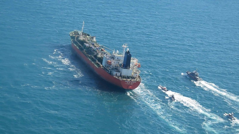 In this photo released Monday, Jan. 4, 2021, by Tasnim News Agency, a seized South Korean-flagged tanker is escorted by Iranian Revolutionary Guard boats on the Persian Gulf. Iranian state television acknowledged that Tehran seized the oil tanker in the Strait of Hormuz. The report on Monday alleged the MT Hankuk Chemi had been stopped by Iranian authorities over alleged “oil pollution” in the Persian Gulf and the strait. (Tasnim News Agency via AP)