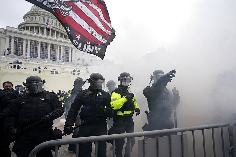 Police hold off Trump supporters who tried to break through a police barrier, Wednesday, Jan. 6, 2021, at the Capitol in Washington. As Congress prepares to affirm President-elect Joe Biden's victory, thousands of people have gathered to show their support for President Donald Trump and his claims of election fraud. (AP Photo/Julio Cortez)