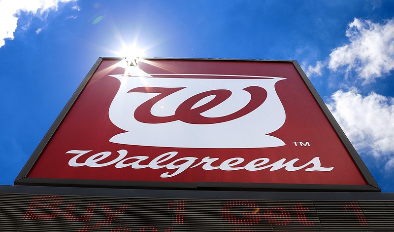 FILE - This June 25, 2019, file photo shows the sign outside a Walgreens Pharmacy in Pittsburgh. Walgreens Boots Alliance will sell its pharmaceutical wholesaler business to AmerisourceBergen in $6.5 billion cash and stock deal. The drugstore chain says the deal will let it invest in and focus on its retail business, which has been hurt by sales declines during the COVID-19 pandemic.  (AP Photo/Gene J. Puskar, File)