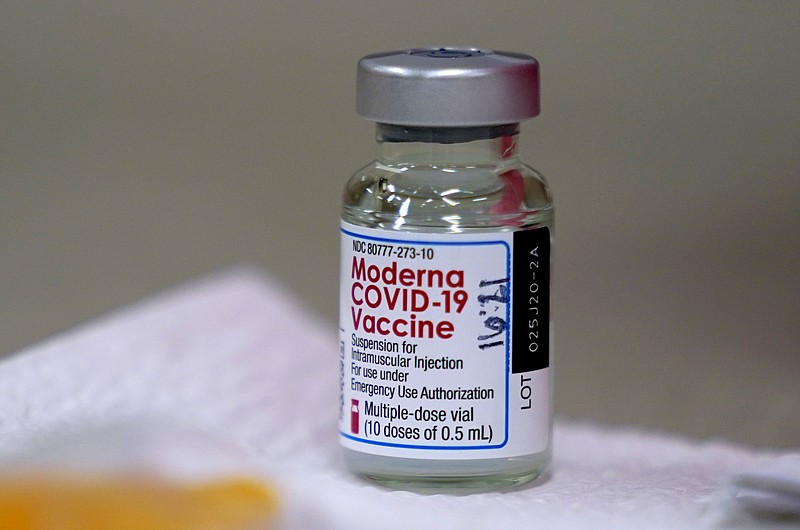 FILE - In this file photo dated Wednesday, Dec. 30, 2020, a bottle of Moderna COVID-19 vaccine on a table before being utilised in Topeka, USA.  The European Union’s medicines agency on Wednesday Jan. 6, 2021, gave the green light to Moderna Inc.’s COVID-19 vaccine, a decision that gives the 27-nation bloc a second vaccine to use to fight the virus rampaging across the continent.(AP Photo/Charlie Riedel, FILE)