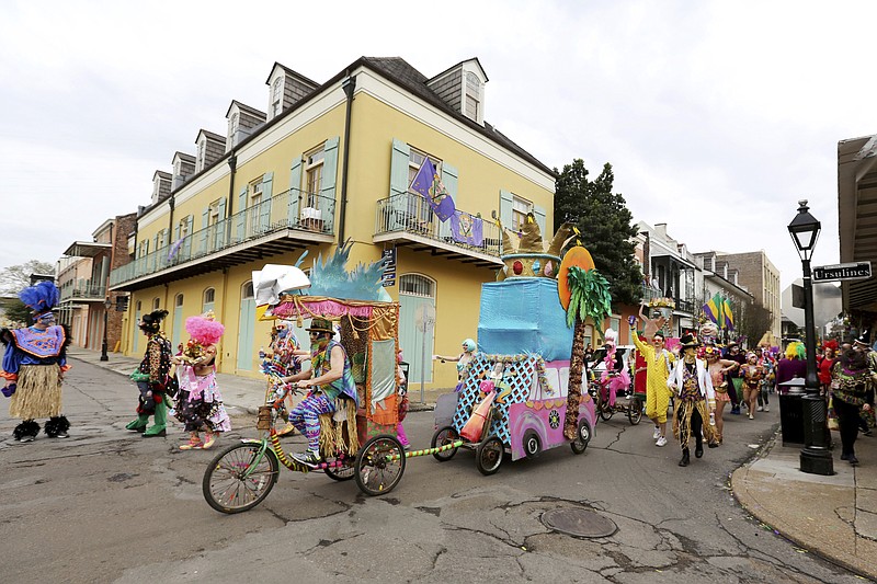 FILE - In this Tuesday, Feb. 25, 2020, file photo, Mondo Kayo parades down Chartres Street during Mardi Gras, in New Orleans. A subdued Carnival season begins Wednesday, Jan. 6, 2021, after the coronavirus pandemic put an end to the crowd-heavy balls and street parades that draw thousands of people to the city every year. (AP Photo/Rusty Costanza, File)