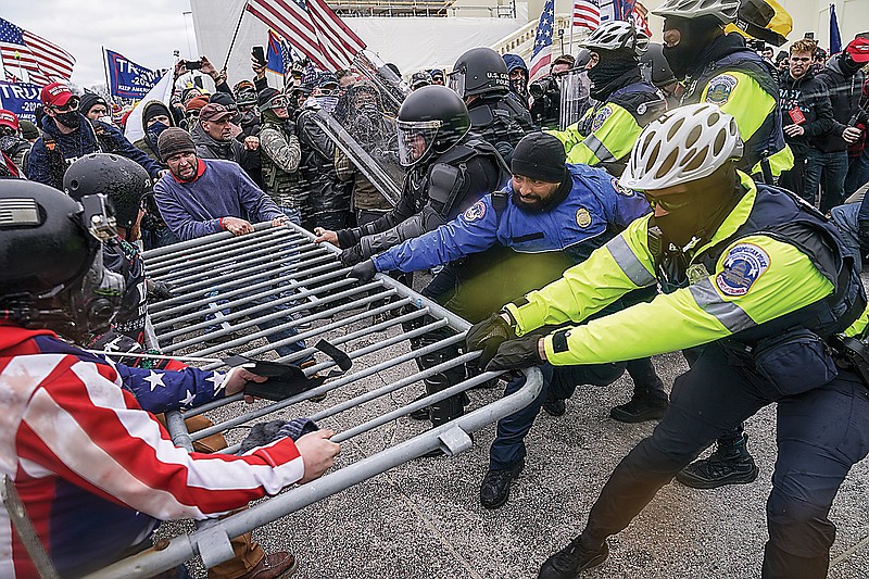 Trump supporters try to break through a police barrier Wednesday at the Capitol in Washington. As Congress prepares to affirm President-elect Joe Biden's victory, thousands of people gathered to show their support for President Donald Trump and his claims of election fraud.