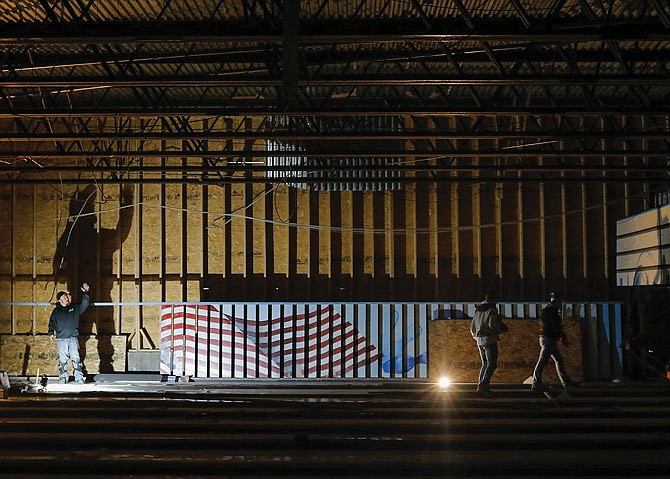 Crew members of Lane Surgeons LLC work Wednesday to strip Capital Bowl's lanes of whatever wood they can salvage. The structure, heavily damaged in the May 2019 tornado, is set to be demolished.  