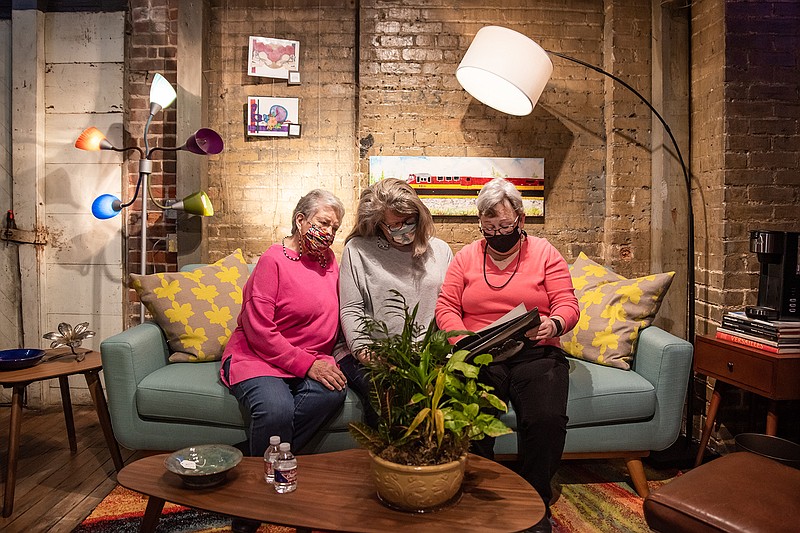 Georgia Hubnik, Kathy Hudson and Debbie Nichols, partners at Arts on Broad, sit in the artist's nook they set up at the 1894 gallery, where their gallery and studio will now reside.