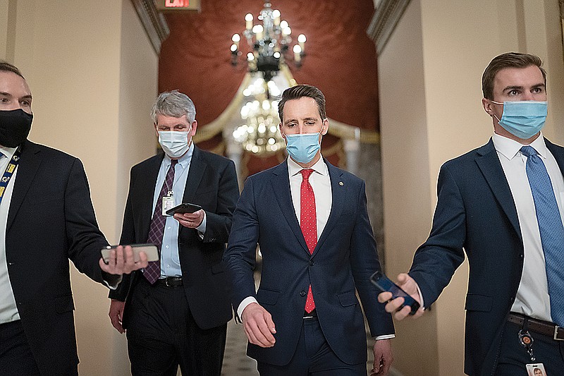 After violent protesters loyal to President Donald Trump stormed the U.S. Capitol today, Sen. Josh Hawley, R-Mo., second from right, walks to the House chamber Wednesday to challenge the results of the presidential election in Pennsylvania during the joint session of the House and Senate to count the Electoral College votes cast in November's election, at the Capitol in Washington.