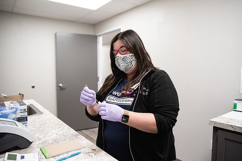 Jennifer Riley prepares a COVID-19 swab to be tested at the newly opened medical clinic on Fouke High School's campus. Doctors and nurses are in office on Mondays and Thursdays.