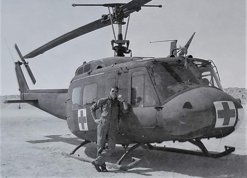 <p>Courtesy of Matt Fife</p><p>Matt Fife is pictured next to one of the UH-1 “Huey” helicopters that he served as a crew chief aboard while deployed with an air ambulance company.</p>