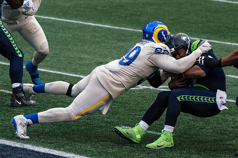 Los Angeles Rams defensive lineman Aaron Donald sacks Seattle Seahawks quarterback Russell Wilson during the second half of an NFL football game in Seattle, in this Sunday, Dec. 27, 2020, file photo. Donald was selected Friday, Jan. 8, 2021, to The Associated Press All-Pro Team. (AP Photo/Stephen Brashear, File)