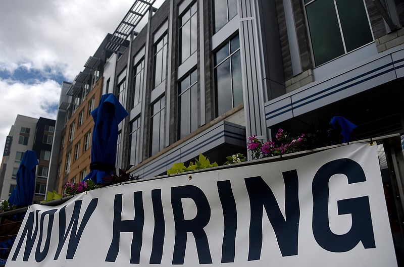 A restaurant displays a "Now Hiring" sign amid the coronavirus pandemic, on Aug. 4, 2020 in Arlington, VA. (Olivier Douliery/AFP via Getty Images/TNS)