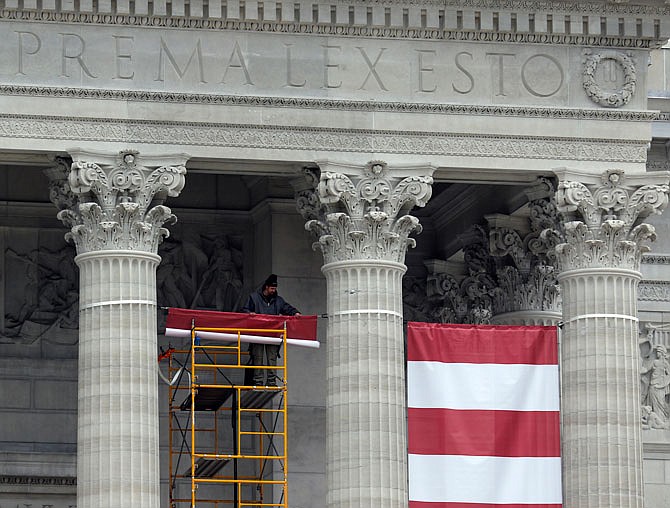 Banners are unfurled between the columns at the front of the Missouri Capitol on Friday in preparation for Monday's inauguration events. 