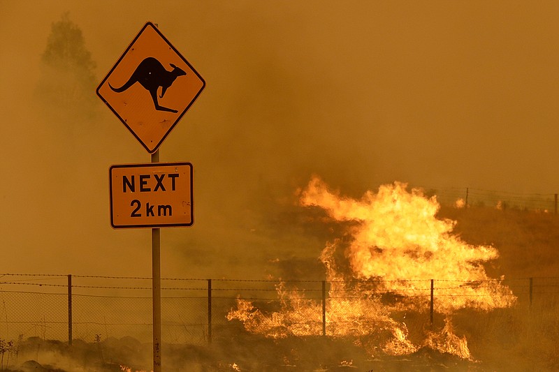 In this  Feb 1, 2020, file photo, a fire burns in the grass near Bumbalong, south of the Australian capital, Canberra. Australia has sweltered through its fourth-hottest year on record despite the usually cooling impact in recent months of the La Nina climate pattern, the nation's weather bureau said on Friday, Jan. 8, 2021. (AP Photo/Rick Rycroft,File)
