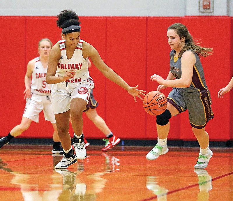 Calvary Lutheran's Izzy Chilambo steals the ball away as Kansas City Lutheran's Hailey Schuster tries to chase her down Saturday at Calvary Lutheran.