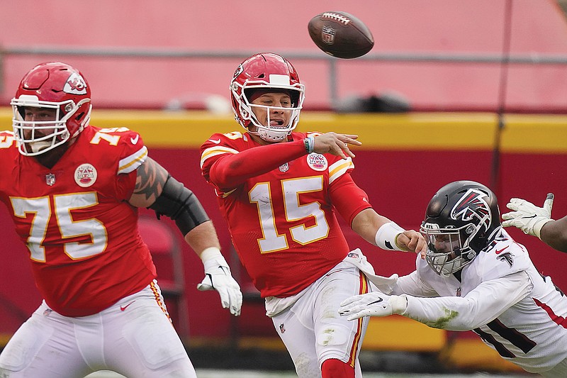 In this Dec. 27, 2020, file photo, Chiefs quarterback Patrick Mahomes throws a pass while being chased down by Jacob Tuioti-Mariner of the Falcons during a game at Arrowhead Stadium.