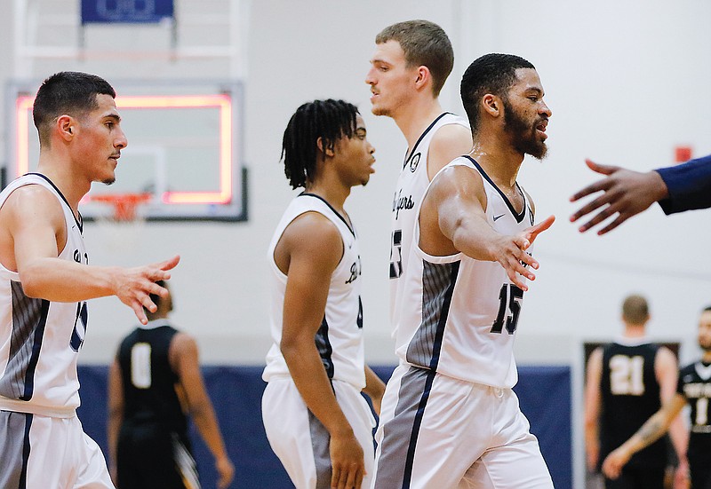 Lincoln teammates congratulate each other after Saturday afternoon's 76-64 win against Fort Hays State at Jason Gym. 