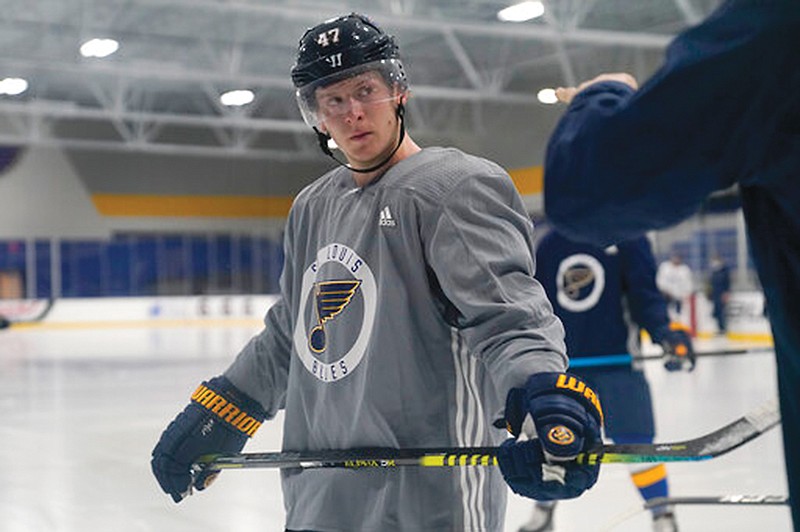 Blues defenseman Torey Krug listens to a member of the coaching staff during a training camp session last week in Maryland Heights.