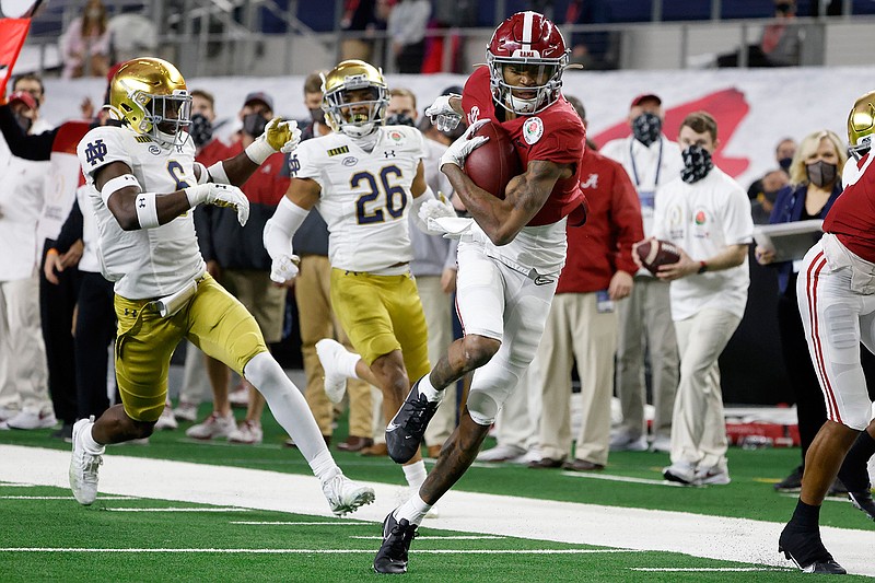 FILE - Alabama wide receiver DeVonta Smith (6) gets past Notre Dame linebacker Jeremiah Owusu-Koramoah (6) and cornerback Clarence Lewis (26) on his way to the end zone for a touchdown in the first half of the Rose Bowl NCAA college football game in Arlington, Texas, in this Friday, Jan. 1, 2021, file photo. The Heisman Trophy winner caught seven passes for 130 yards and three touchdowns as No. 1 Alabama beat No. 4 Notre Dame in a College Football Playoff semifinal.(AP Photo/Michael Ainsworth, File)