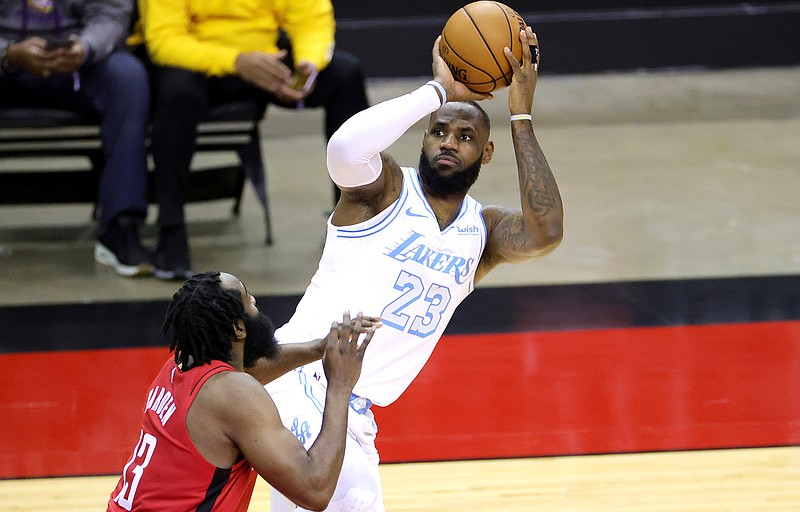 LeBron James, right, of the Los Angeles Lakers puts up a jump shot ahead of James Harden, left, of the Houston Rockets during the first quarter of an NBA basketball game Sunday, Jan. 10, 2021, in Houston, Texas. (Carmen Mandato/Pool Photo via AP)