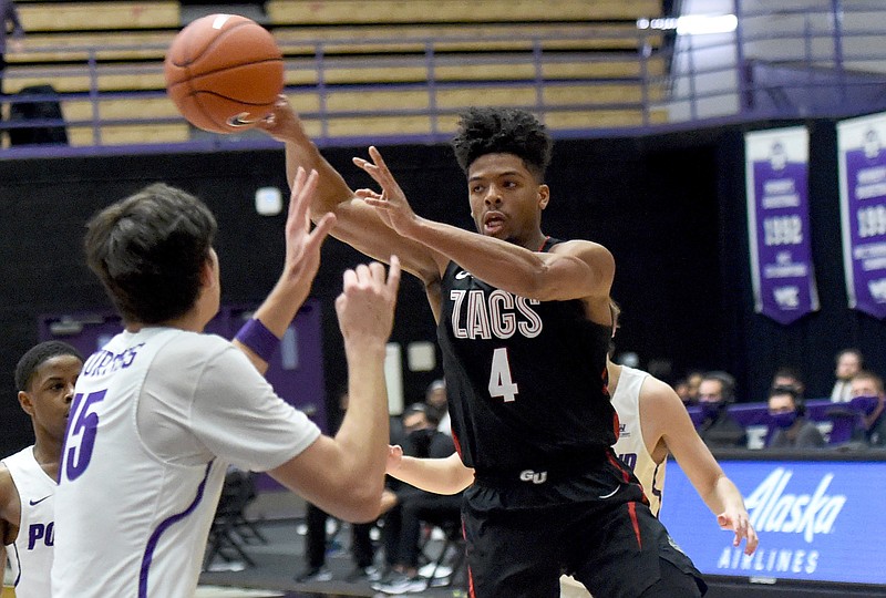 Gonzaga guard Aaron Cook, right, passes the ball past Portland forward Hayden Curtiss, left, during the second half of an NCAA college basketball game in Portland, Ore., Saturday, Jan. 9, 2021. (AP Photo/Steve Dykes)