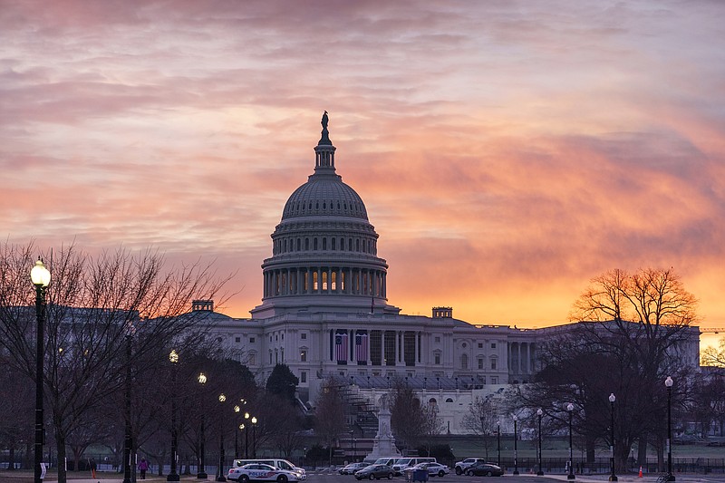 Dawn breaks at the Capitol in Washington, Monday, Jan. 11, 2021. House Speaker Nancy Pelosi, D-Calif., is calling for congressional action to rein in President Donald Trump after inciting last week's deadly assault on the U.S. Capitol. (AP Photo/J. Scott Applewhite)