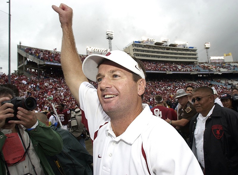 In this Oct. 9, 2004, file photo, Oklahoma coach Bob Stoops celebrates the Sooners' 12-0 win against Texas, in Dallas. Stoops and Heisman Trophy winner Carson Palmer are among the 13 former players and coaches who make up the latest College Football Hall of Fame class, which was announced Monday.