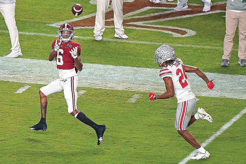 Alabama wide receiver DeVonta Smith catches a touchdown pass behind Ohio State cornerback Shaun Wade during the first half of Monday's College Football Playoff national championship game in Miami Gardens, Fla.