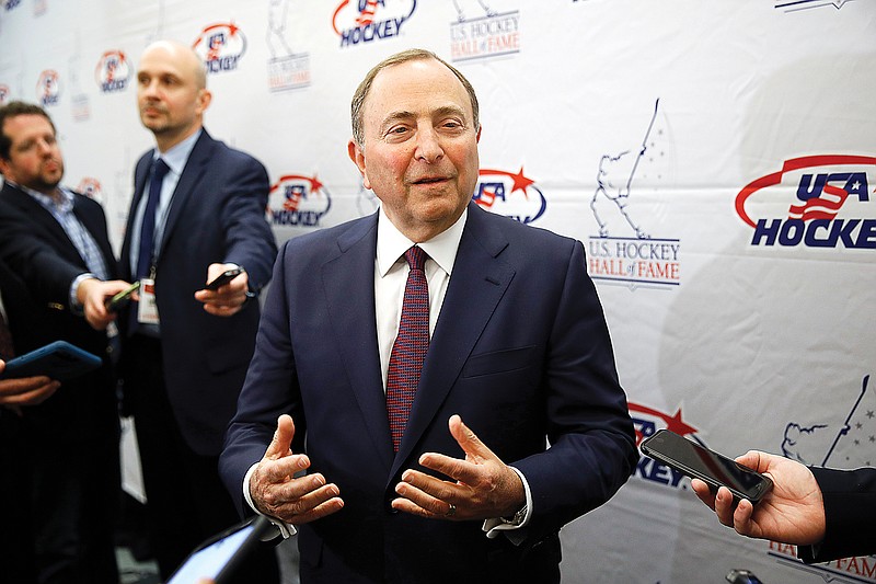 In this Dec. 12, 2019, file photo, NHL commissioner Gary Bettman speaks with members of the media before being inducted into the U.S. Hockey Hall of Fame in Washington.