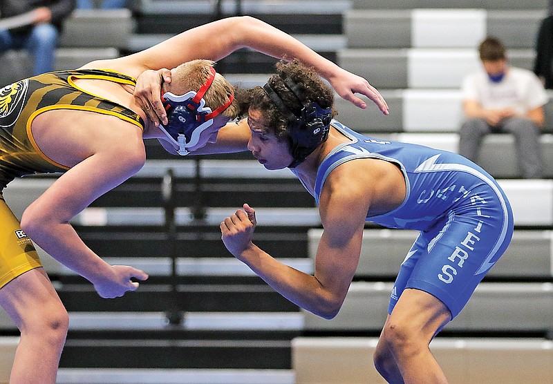 Capital City's Eli Jenkins (right) wrestles against Sedalia Smith-Cotton's Keaton Belsha during their match at 145 pounds in Tuesday's dual at Capital City High School.