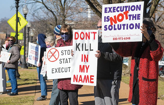 About a dozen people gathered Tuesday to express their views on the death penalty as they protest the impending executions of three federal inmates: Lisa Montgomery, who has a temporary stay; Corey Johnson; and Dustin Higgs. They are from Missourians for Alternatives to the Death Penalty, a statewide organization working to repeal the death penalty in Missouri.