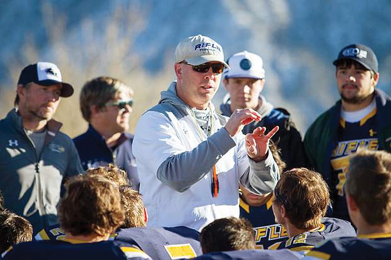 In this 2017 photo, Rifle football coach Damon Wells speaks to players after a Class 3 Colorado High School Activities Association playoff game against Palmer Ridge in Rifle, Colo.