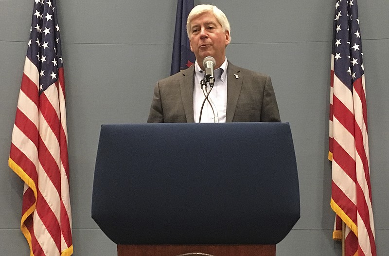 FILE - In this Tuesday, Sept. 25, 2018, file photo, then-Michigan Gov. Rick Snyder speaks with reporters during a news conference at his office in Lansing, Mich. Former Michigan Gov. Rick Snyder has been charged with two counts of willful neglect of duty in the Flint water crisis. (AP Photo/David Eggert, File)