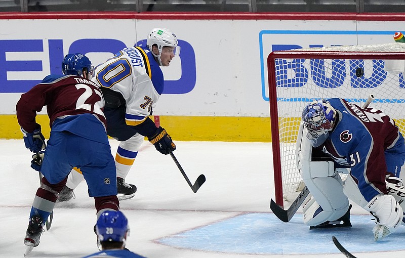 Blues center Oskar Sundqvist (background) drives past Avalanche defenseman Conor Timmins (left) to score a goal against goaltender Philipp Grubauer in the third period of Wednesday's game in Denver. The Blues won 4-1.