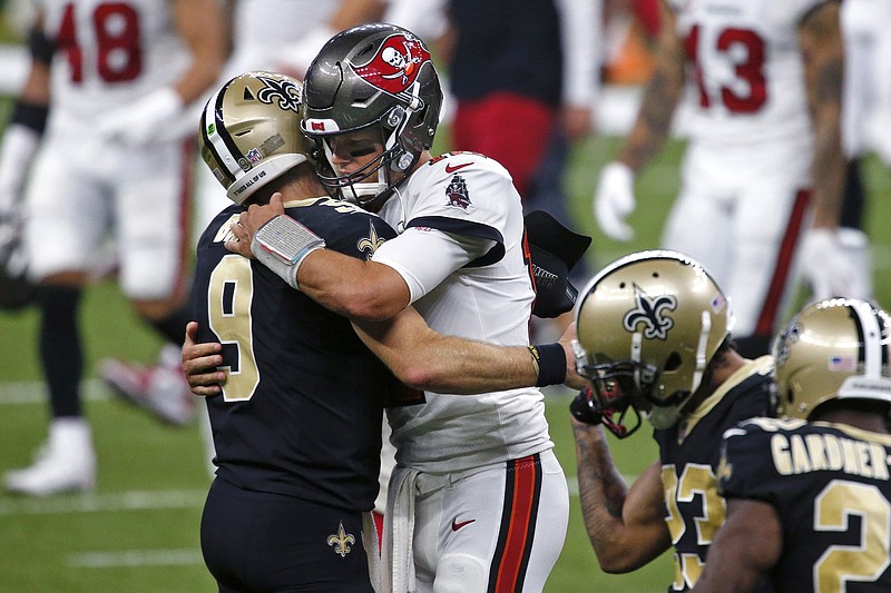 In this Sept. 13, 2020, file photo, Saints quarterback Drew Brees and Buccaneers quarterback Tom Brady hug after a game in New Orleans.