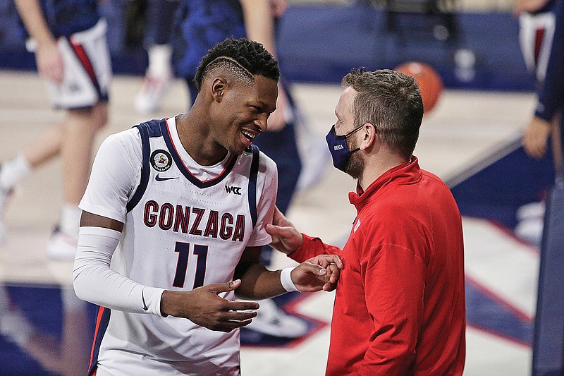 Gonzaga head athletic trainer Josh Therrien (right) speaks with guard Joel Ayayi before the team's game Thursday against Pepperdine in Spokane, Wash.