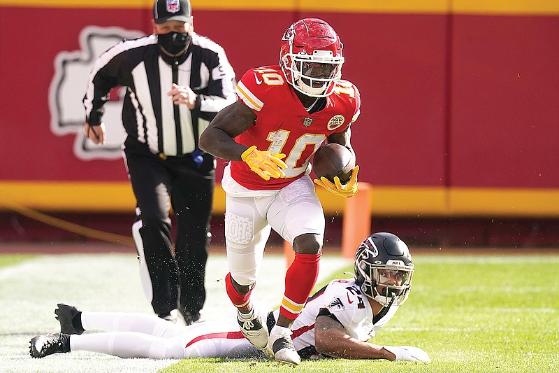 Chiefs wide receiver Tyreek Hill runs down the sideline after evading a tackle by the Falcons' A.J. Terrell during last month's game at Arrowhead Stadium.