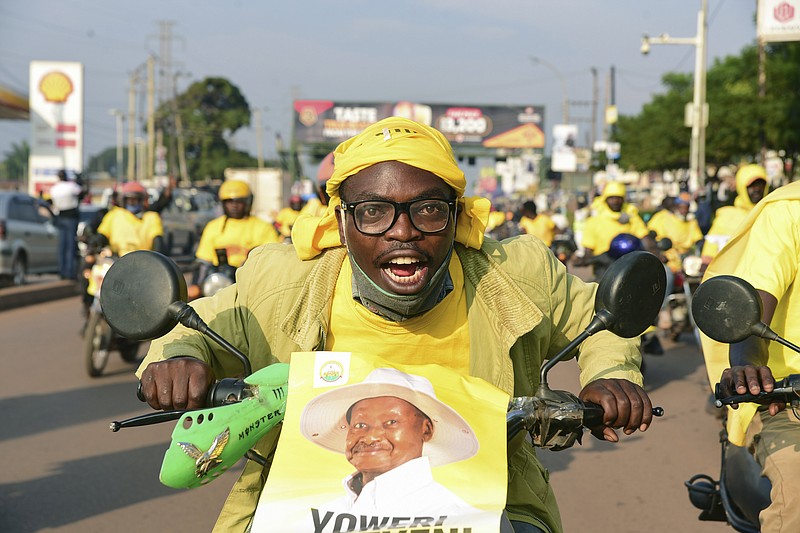 A supporter of Ugandan President Yoweri Kaguta Museveni celebrates in Kampala, Uganda, Saturday Jan. 16, 2021, after their candidate was declared winner of the presidential elections.  Uganda’s electoral commission says longtime President Yoweri Museveni has won a sixth term, while top opposition challenger Bobi Wine alleges rigging and officials struggle to explain how polling results were compiled amid an internet blackout. In a generational clash widely watched across the African continent, the young singer-turned-lawmaker Wine posed arguably the greatest challenge yet to Museveni. (AP Photo/Nicholas Bamulanzeki)