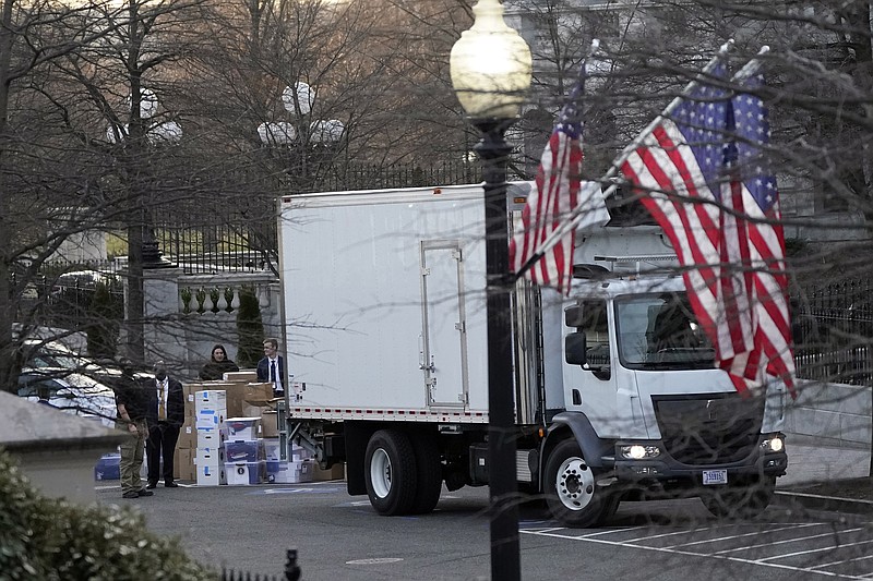 A van arrives to pick up boxes that were moved out of the Eisenhower Executive Office building, inside the White House complex, Thursday, Jan. 14, 2021, in Washington. Inauguration Day is also moving day at the White House. (AP Photo/Gerald Herbert)