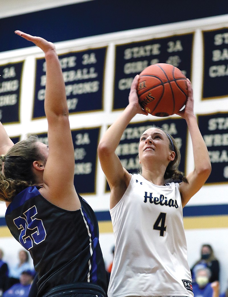 Kylie Bernskoetter of Helias puts up a shot against Boonville's Kourtney Kendrick during Saturday night's game at Rackers Fieldhouse.