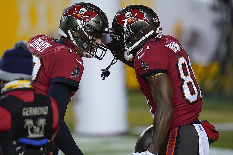 Buccaneers quarterback Tom Brady (left) and wide receiver Antonio Brown celebrate a touchdown pass during last Saturday's playoff game against Washington in Landover, Md.