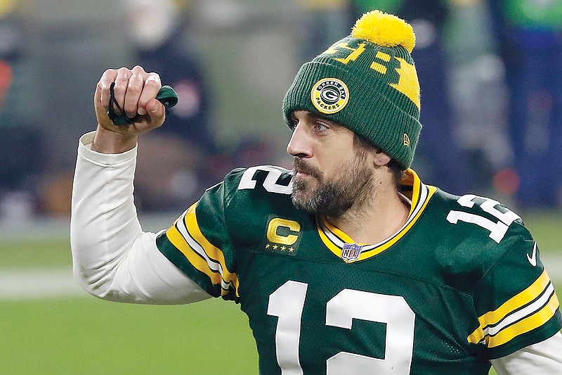 Packers quarterback Aaron Rodgers pumps his fist after Saturday's 32-18 win against the Rams in Green Bay, Wis.